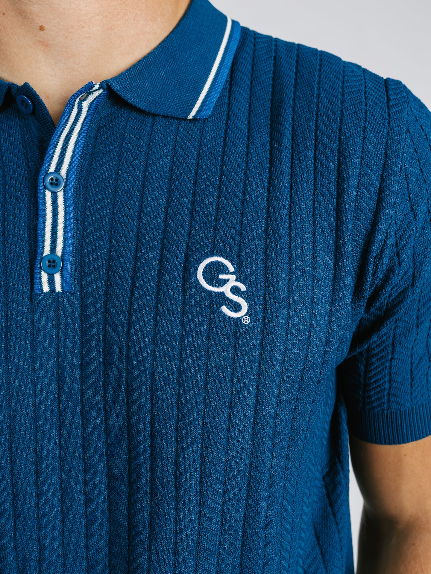 Georgia Southern men's navy ribbed polo shirt by Arena Graffiti, featuring the "GS" logo and classic polo design.
