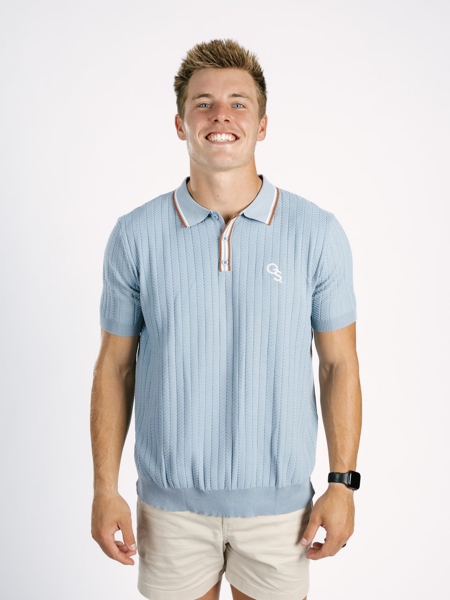 Light blue Georgia Southern men's ribbed polo shirt by Arena Graffiti with a "GS" logo, displayed on a mannequin.