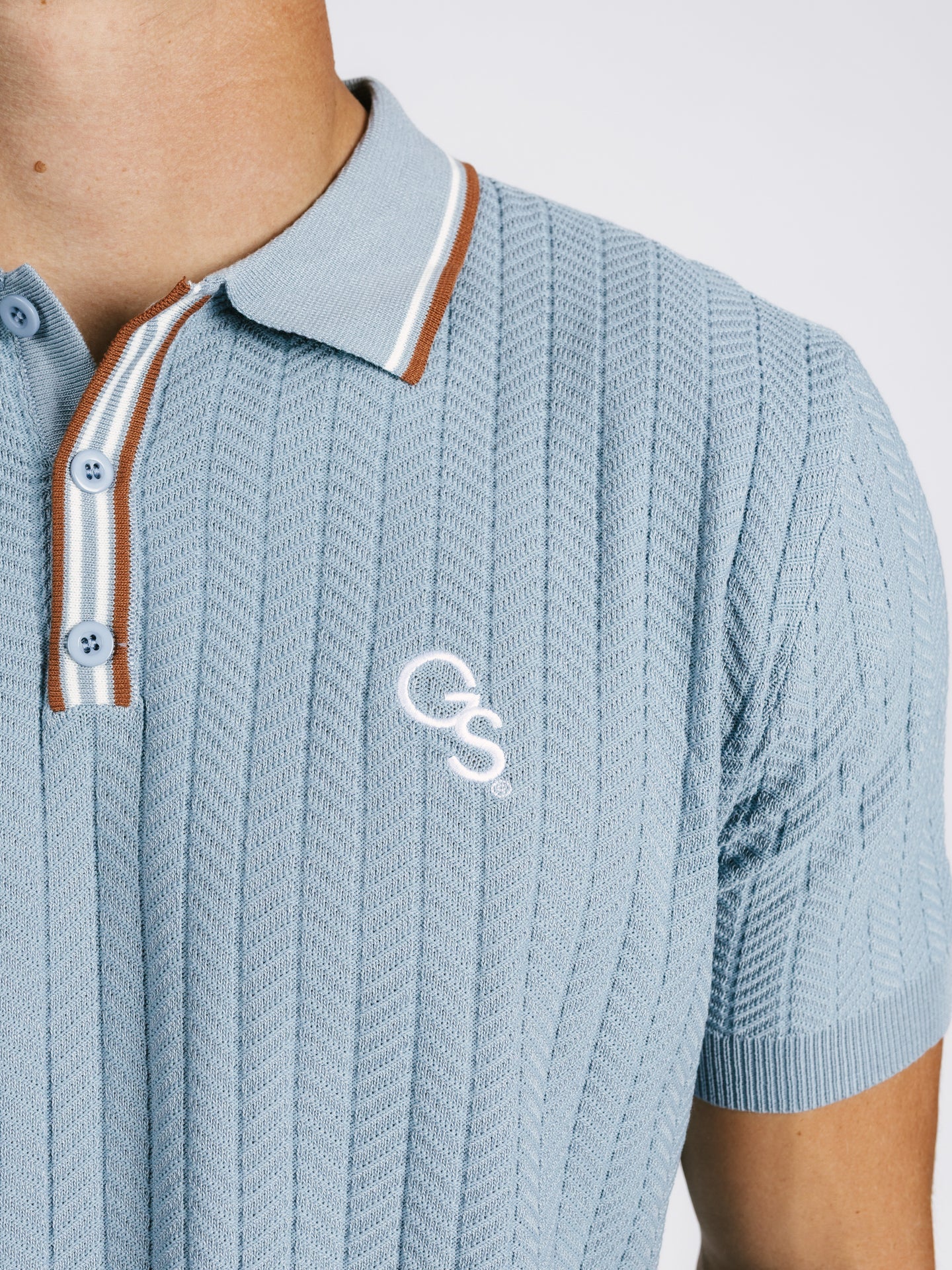 Light blue Georgia Southern men's ribbed polo shirt by Arena Graffiti, featuring the "GS" logo and classic polo design.