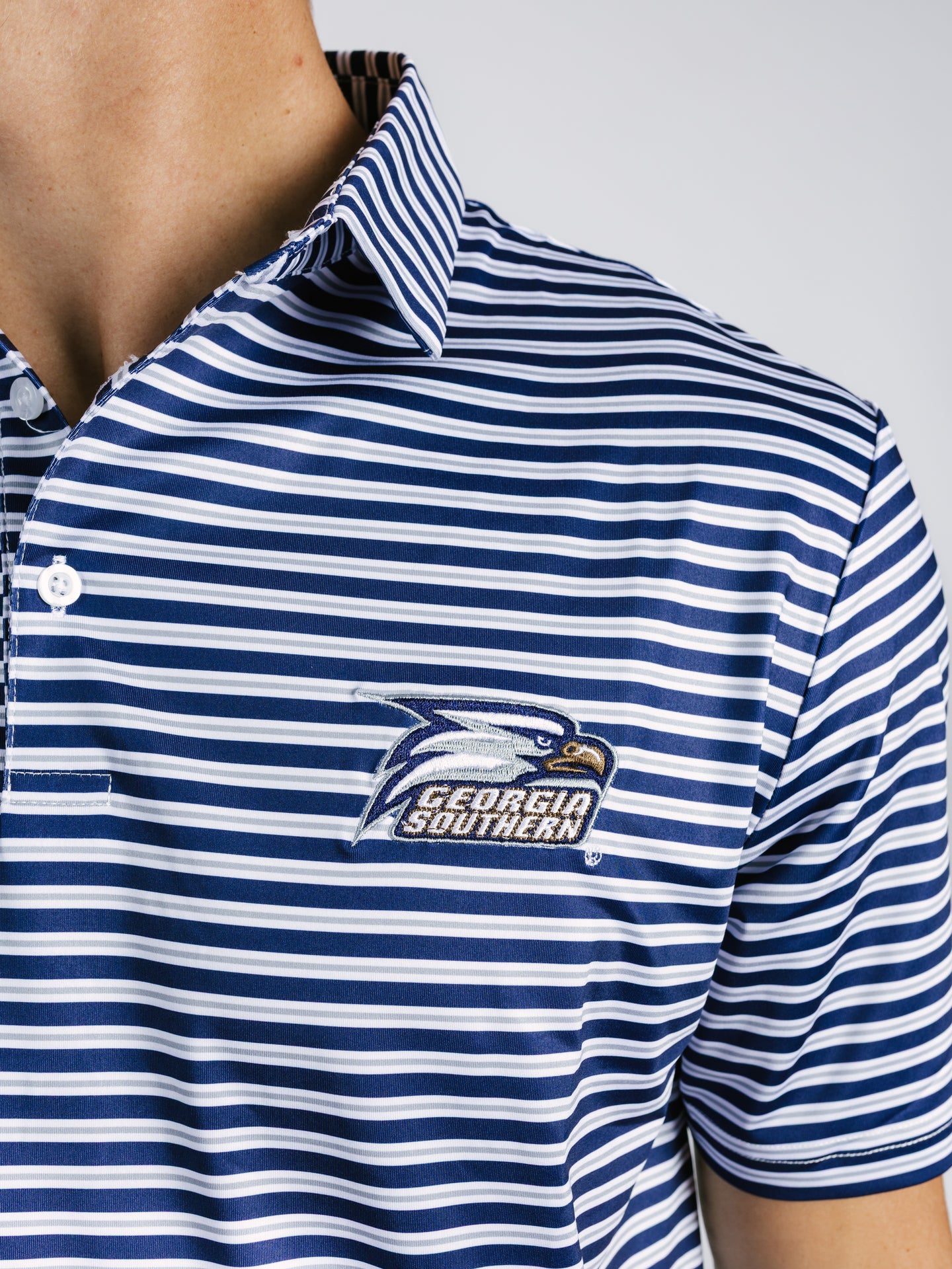 Georgia Southern men's striped eagle polo shirt by Arena Graffiti, featuring a classic collar and team logo on the chest.