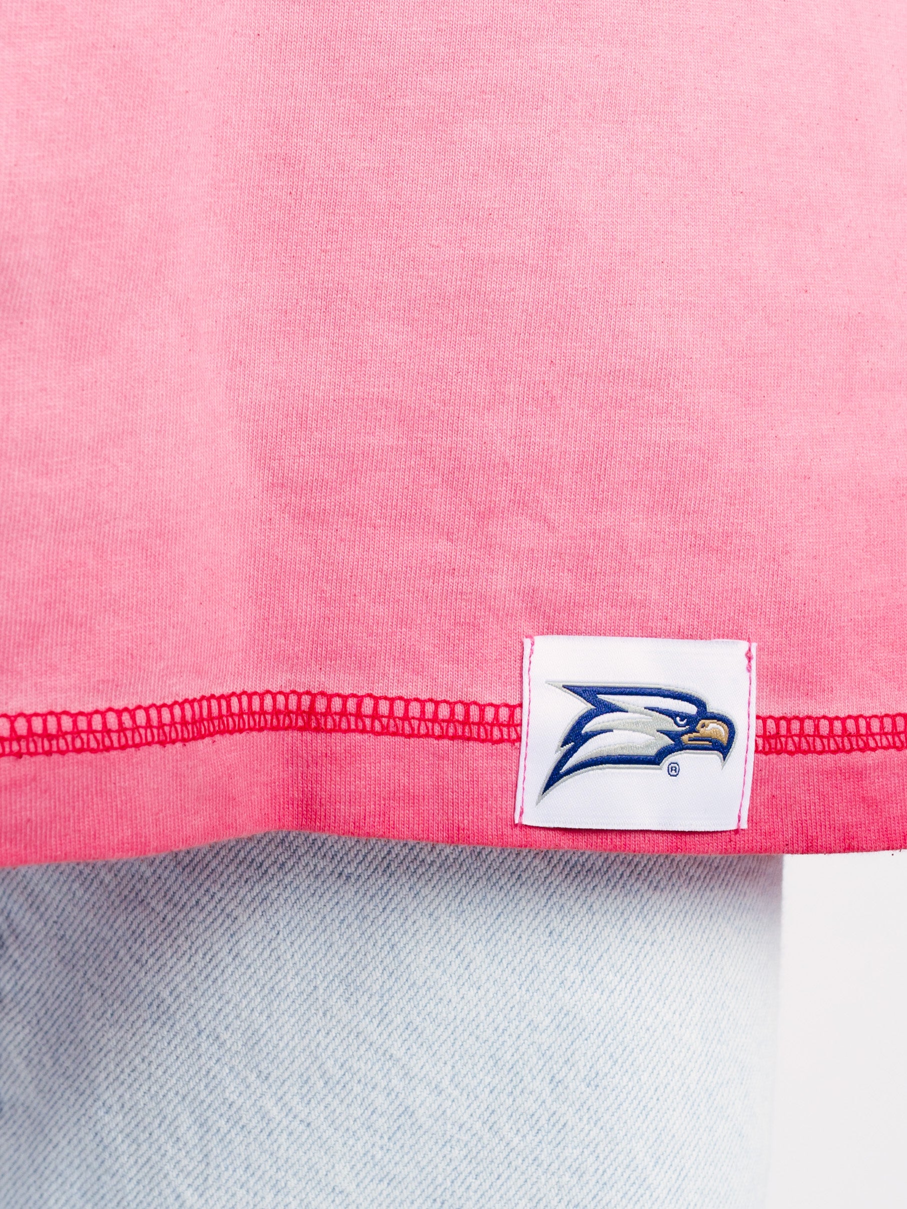 Georgia Southern men's pink acid wash tee featuring "Eagles GATA" graphic, by Arena Graffiti, shown on a model.