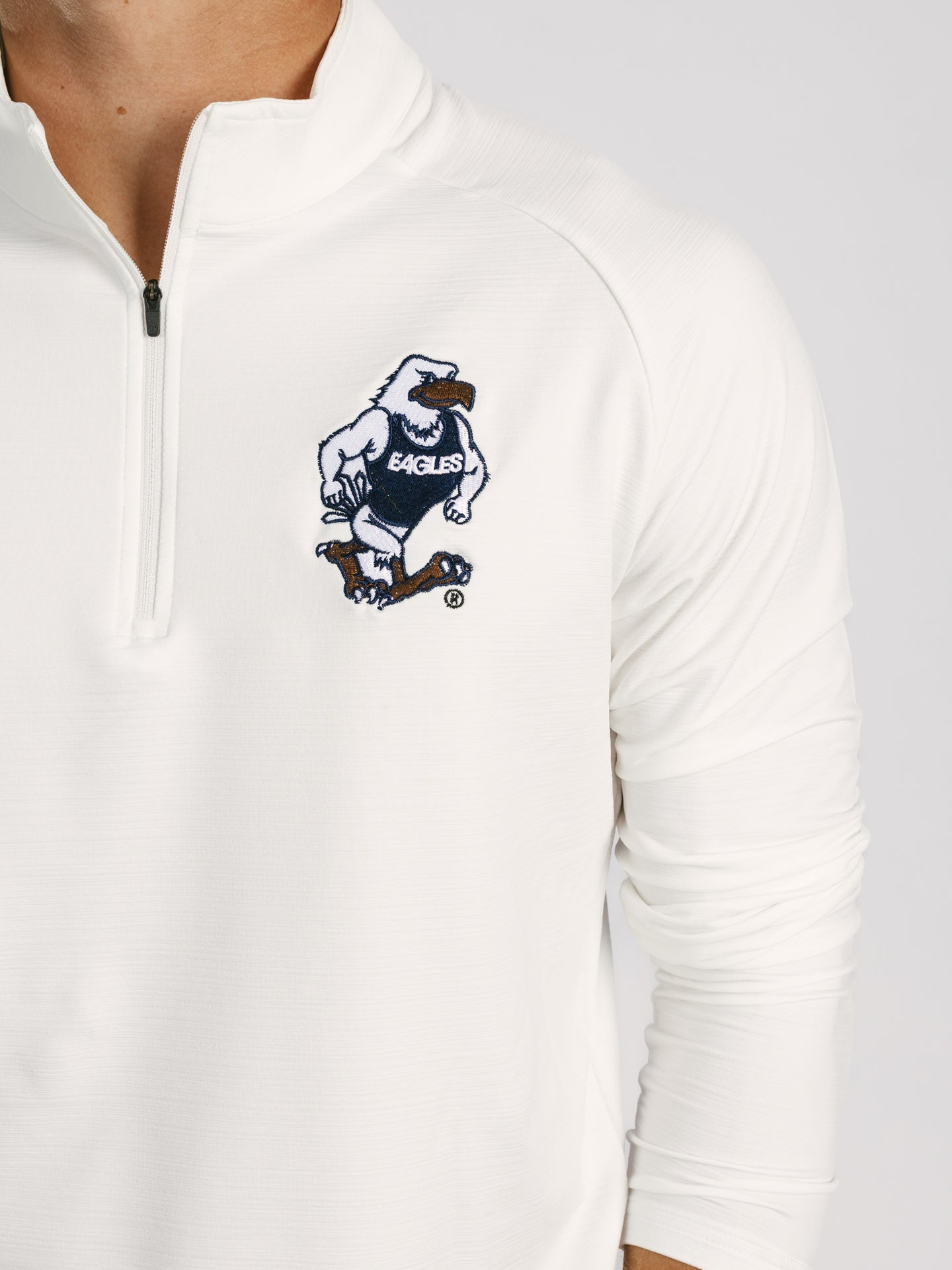 Arena Graffiti Georgia Southern men's white "Strutter" 1/4 zip athletic shirt displayed on a hanger.