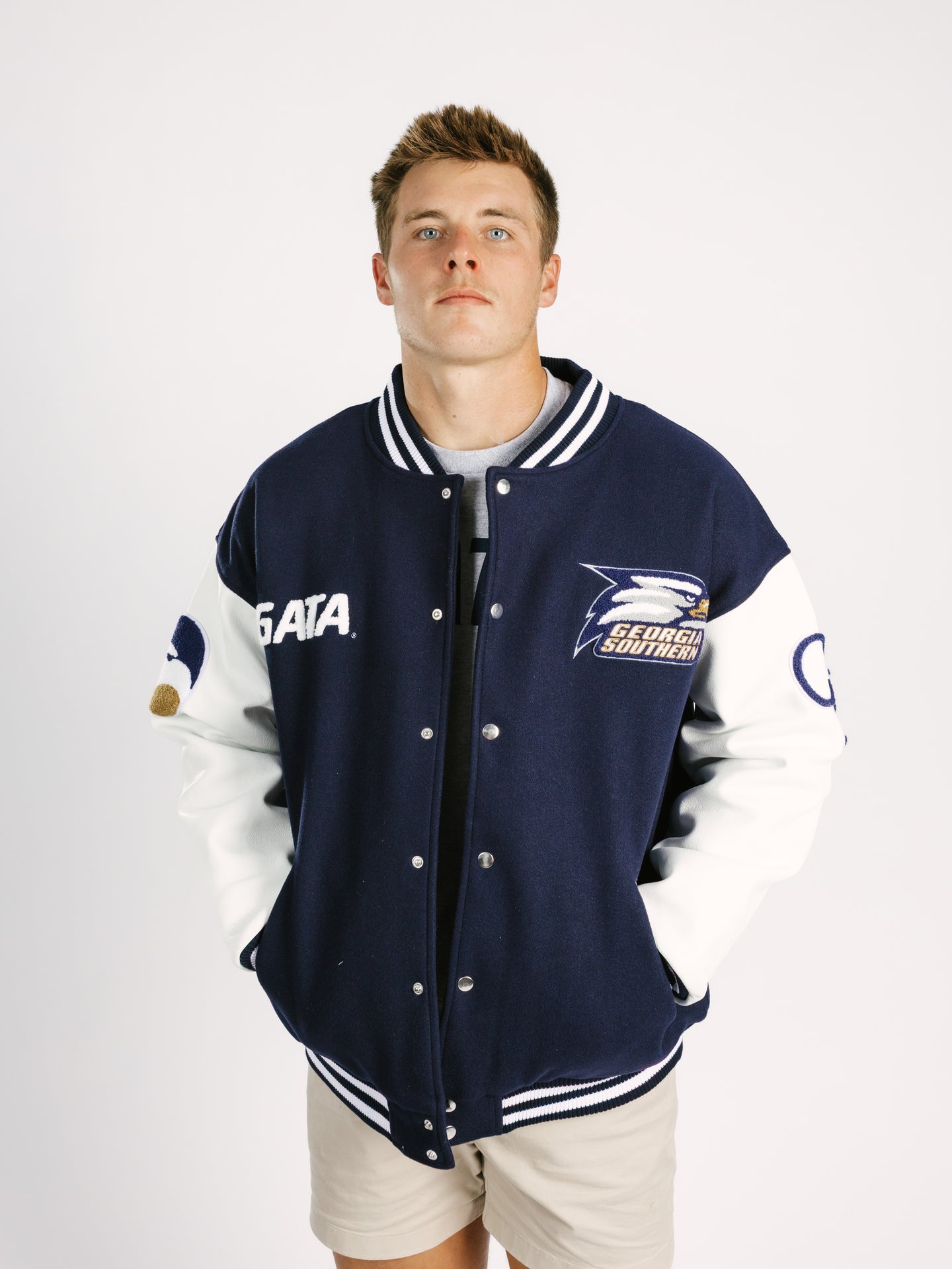 Georgia Southern men's varsity letterman jacket by Arena Graffiti, featuring team emblem and striped cuffs on a navy background.