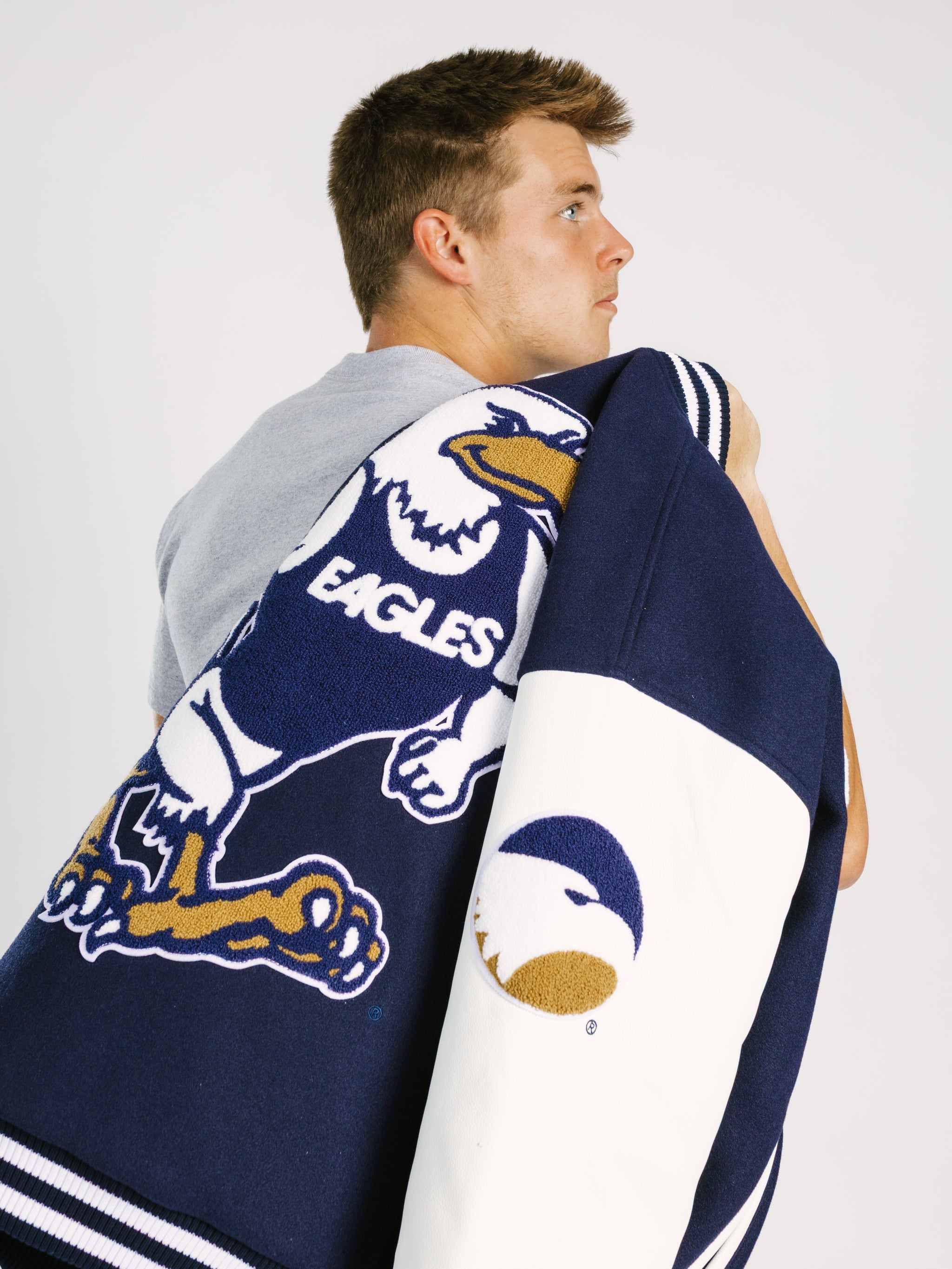 Georgia Southern Men's Varsity Strutter Letterman Jacket by Arena Graffiti, navy blue with white and gold accents, front view.