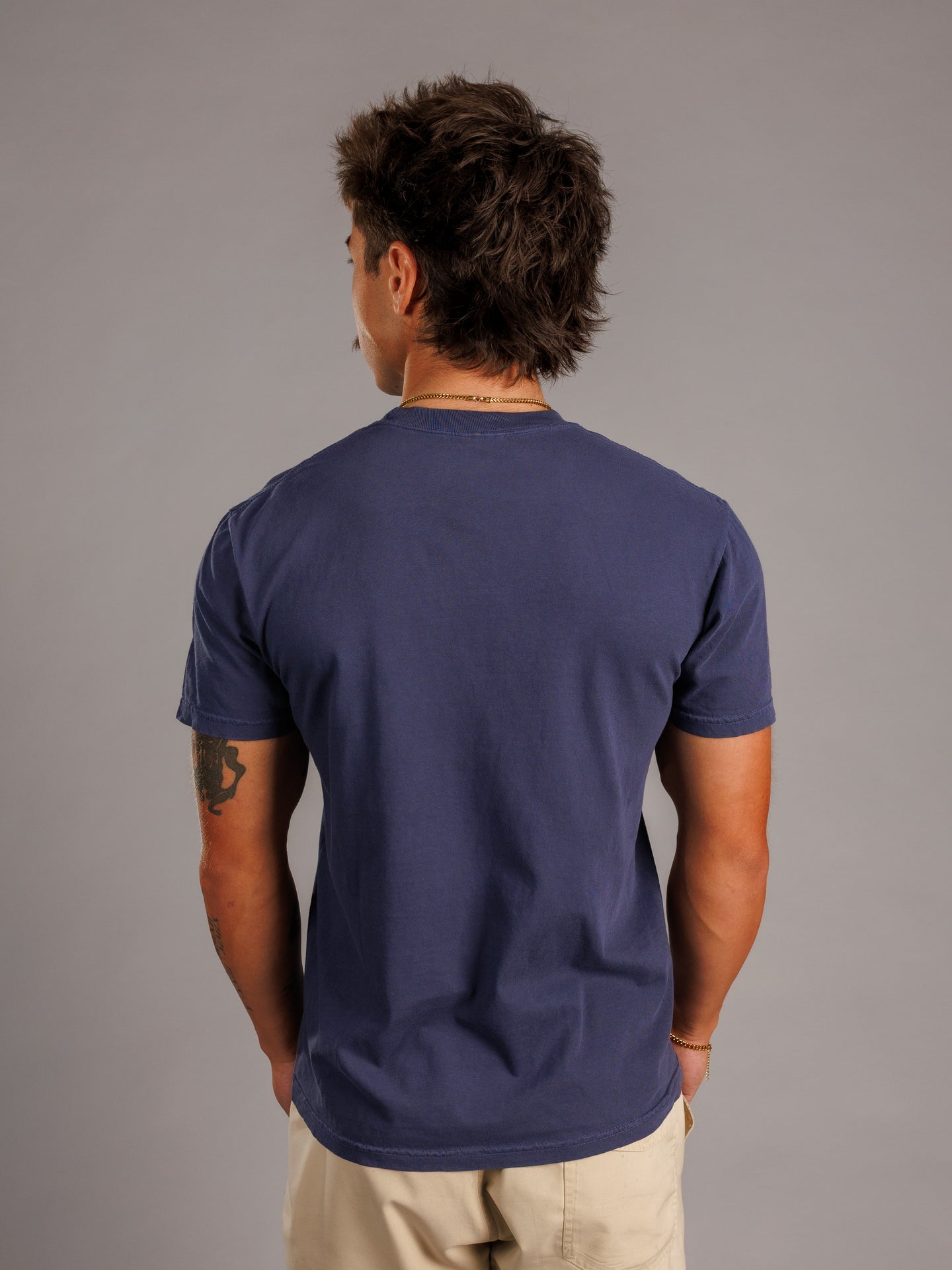 Augusta University men's navy T-shirt featuring the Augusta Jag Head logo, designed by Arena Graffiti.