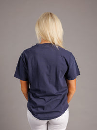 Navy men's T-shirt featuring Augusta University Jaguars logo and branding, made by Arena Graffiti, displayed on a hanger.
