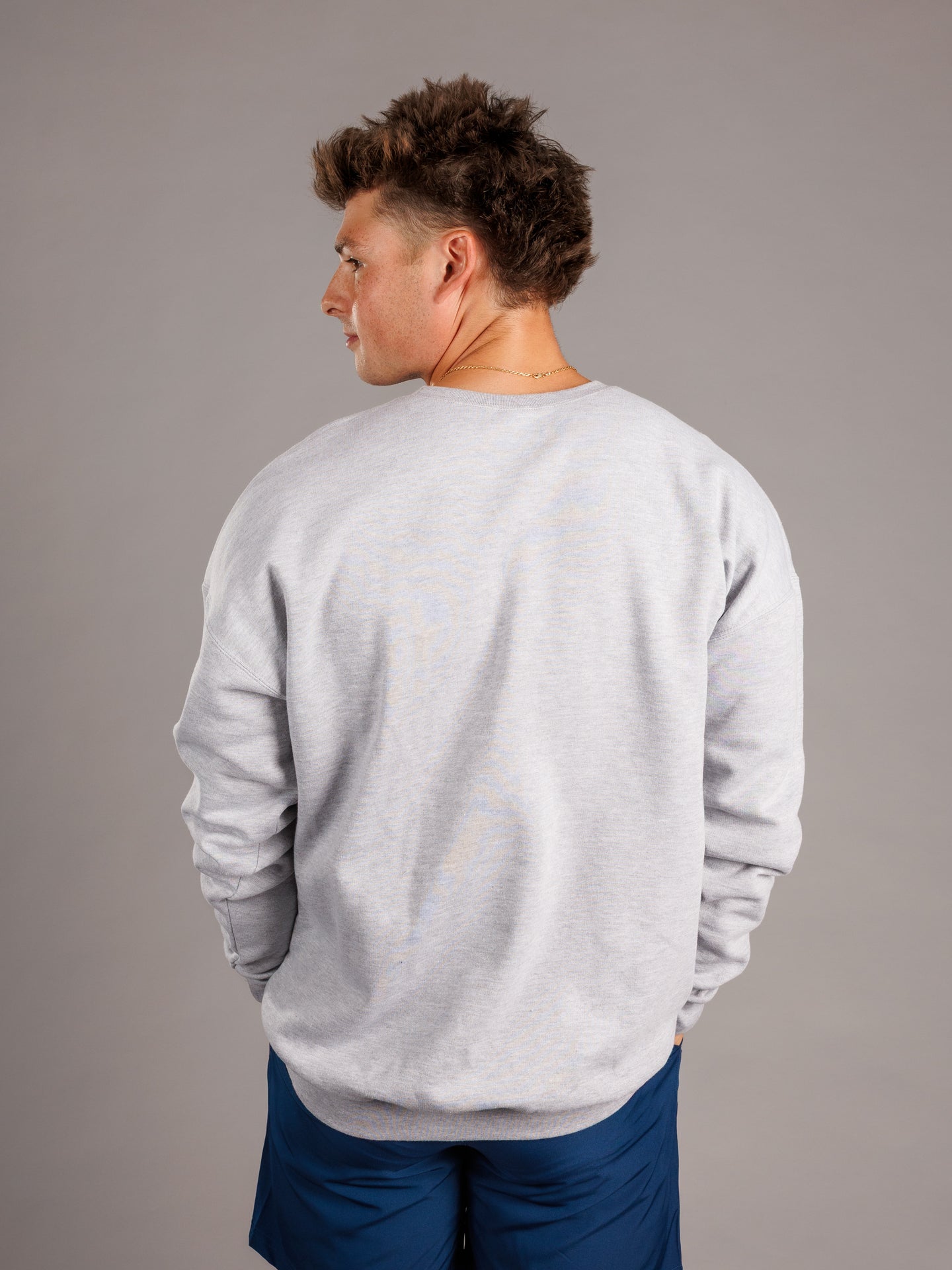 Grey Augusta University men's crewneck sweatshirt featuring the Augusta Jag Head logo, branded by Arena Graffiti.