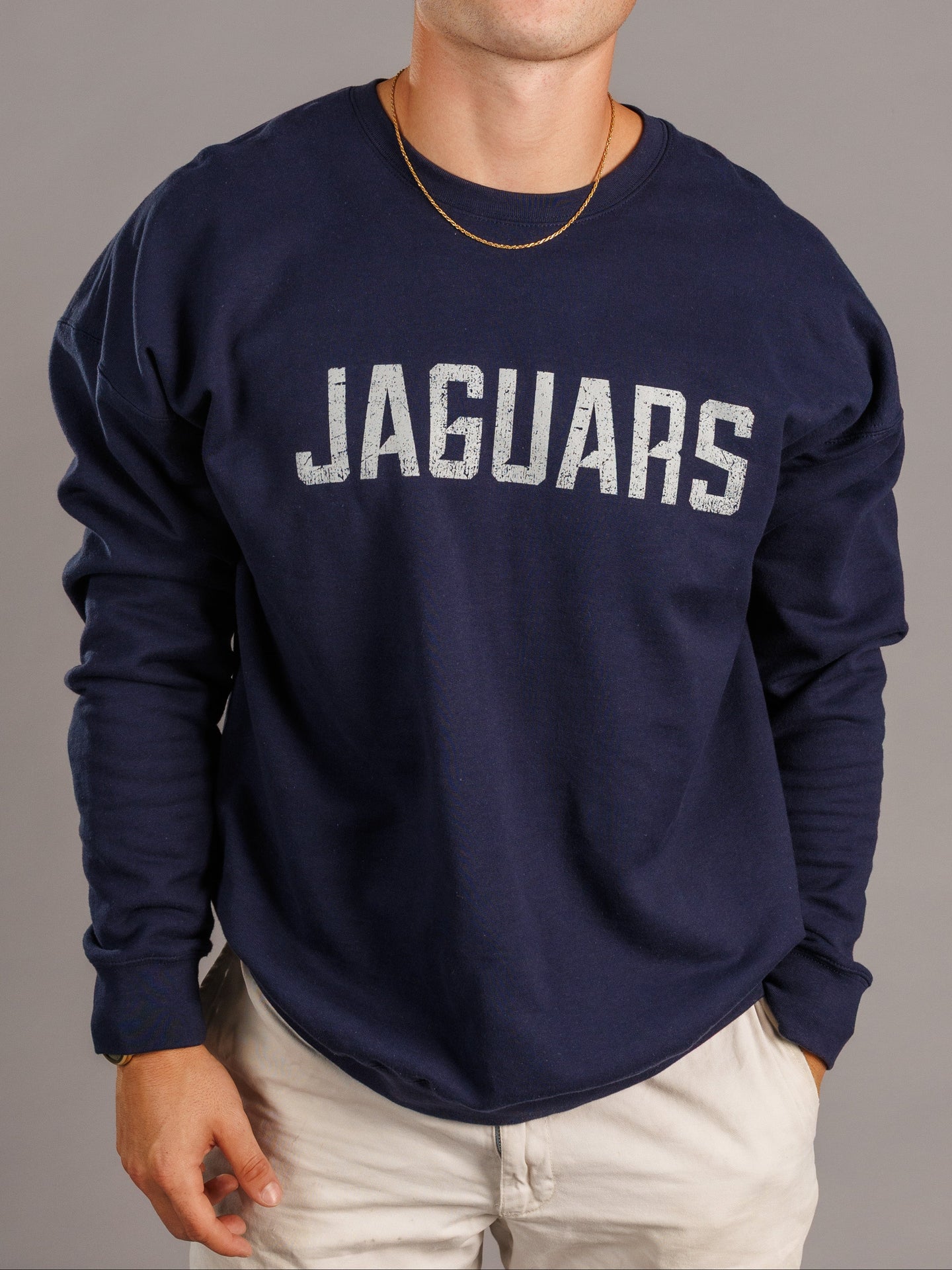 Navy men's crewneck sweatshirt featuring Augusta University Jaguars logo by Arena Graffiti, laid flat on a white background.