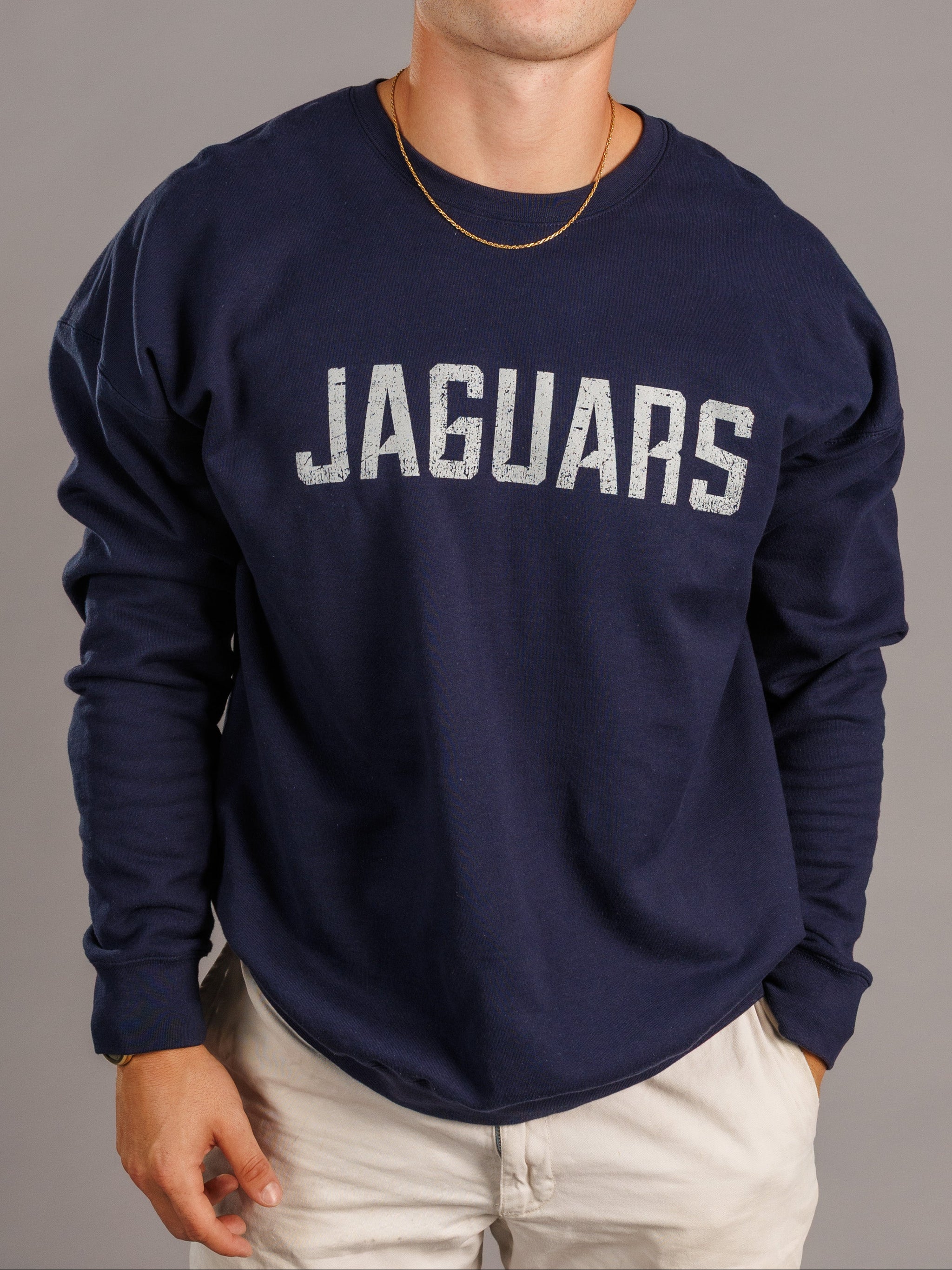 Navy men's crewneck sweatshirt featuring Augusta University Jaguars logo by Arena Graffiti, laid flat on a white background.
