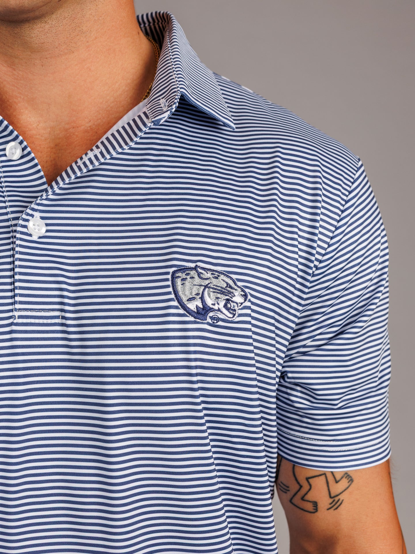 Arena Graffiti Augusta University men's Jag Head striped polo shirt featuring blue, white, and red horizontal stripes.