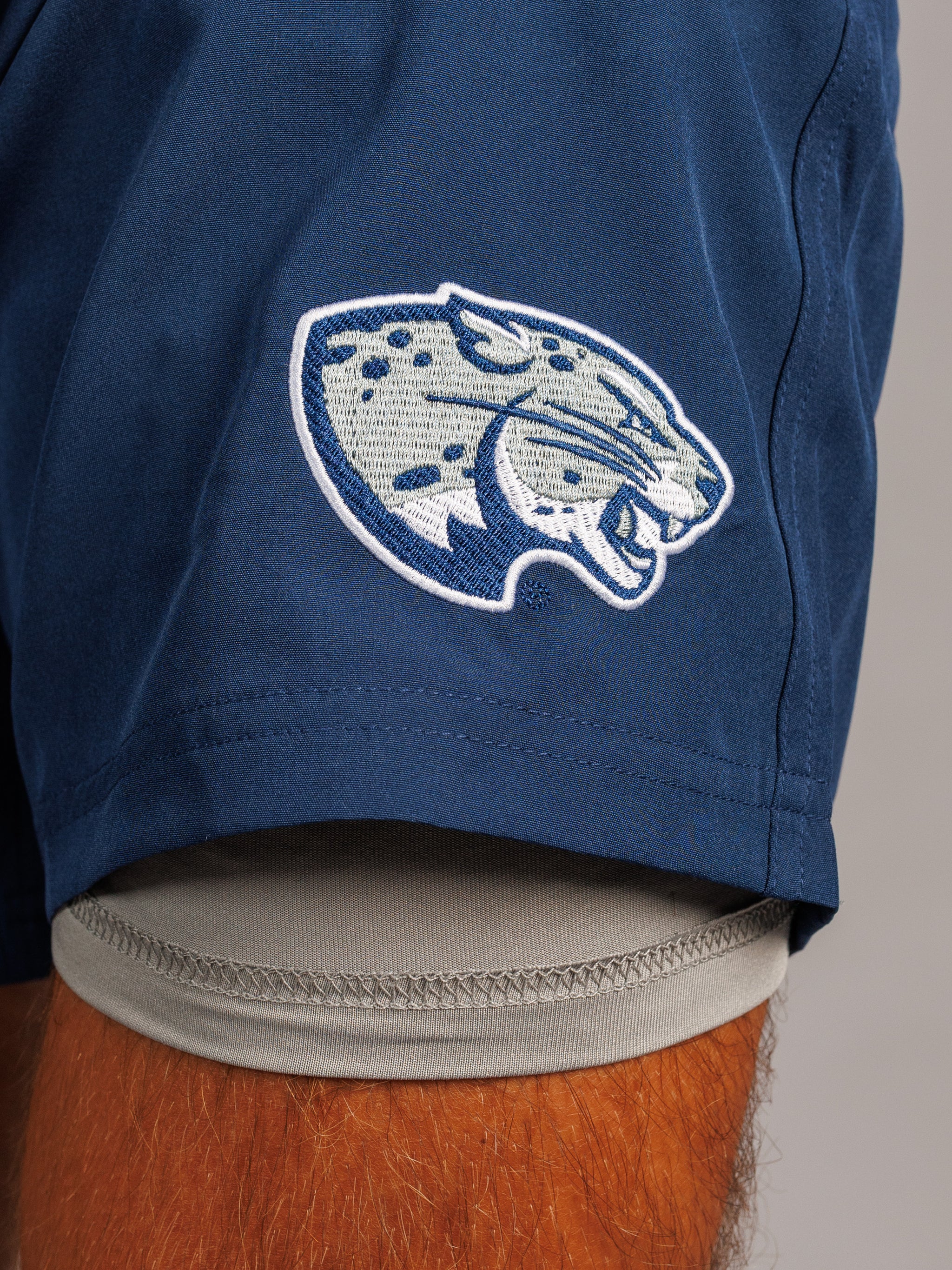 Men's navy lined shorts featuring Augusta University "Jag Head" logo, made by Arena Graffiti, casual athletic wear.
