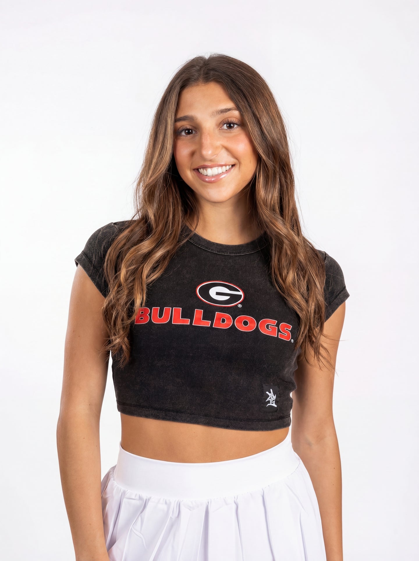 UGA Bulldogs women's "Oval G Bulldogs" crop top by Arena Graffiti, featuring team logo and stylish design on light fabric.