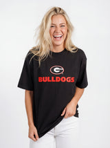 UGA Bulldogs Women's Bulldog Heavyweight Tee by Arena Graffiti, showing a navy blue T-shirt with Bulldogs logo and team graphics.