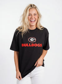 UGA Bulldogs Women's Bulldog Heavyweight Tee by Arena Graffiti, showing a navy blue T-shirt with Bulldogs logo and team graphics.