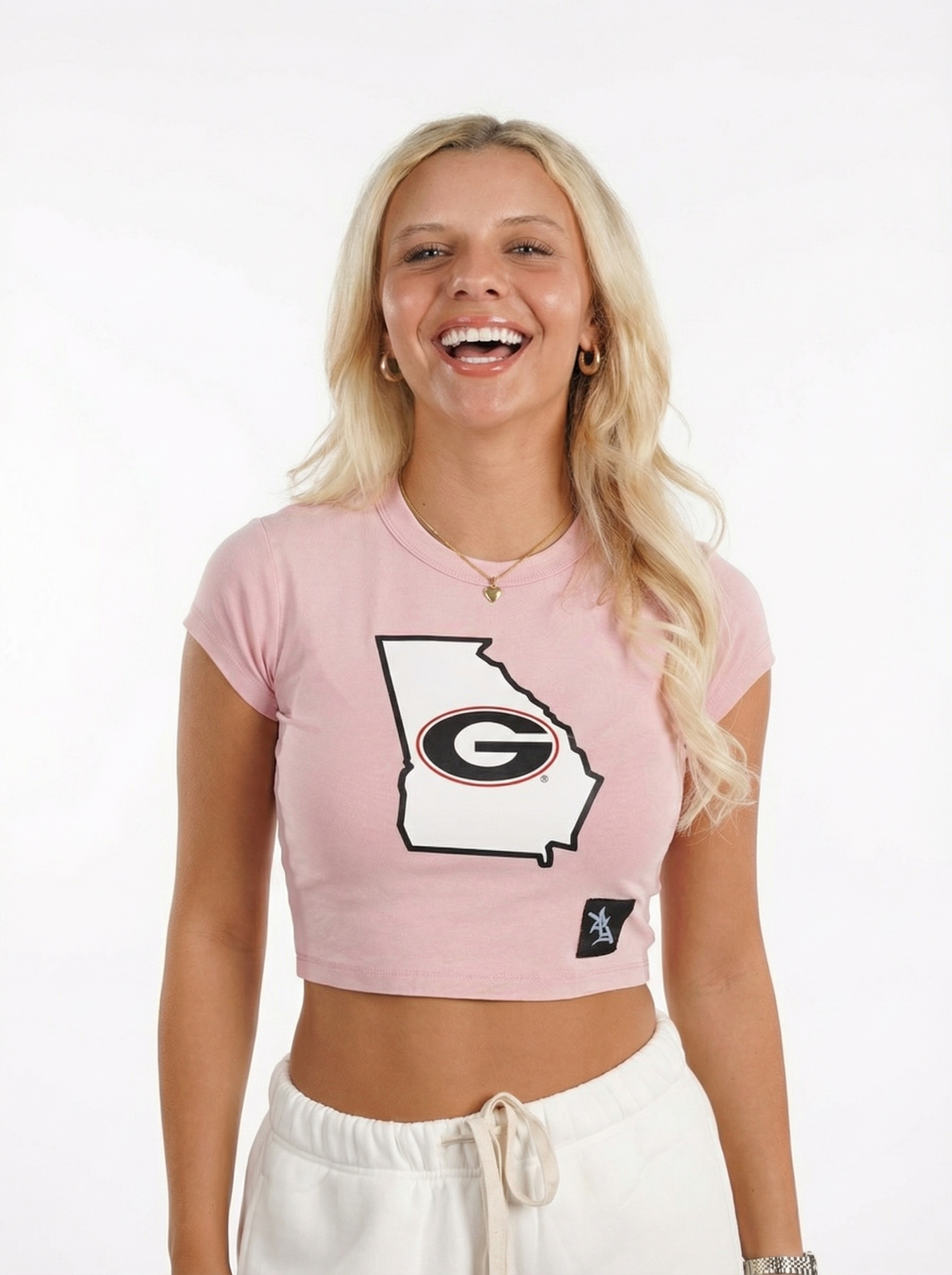 UGA Bulldogs women’s “Blush State” crop top by Arena Graffiti, featuring team logo and pink fabric, worn by a model.